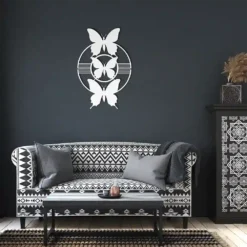 White butterfly silhouette steel wall art display in dark living room