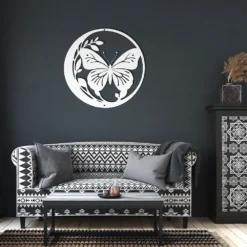 White circled butterfly and foliage metal art showcase in a dark living room