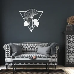 White triangle-framed Ginkgo Leaves Metal Wall Art in dark living room