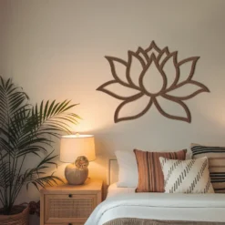 Steel lotus outline art with copper/brown powder coating finish display in cozy bedroom