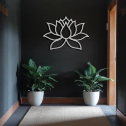 Silver finish lotus outline decor on a dark-walled hallway