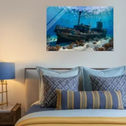 A cozy wall bedroom showcasing our sunlit ocean depths with shipwreck & reef acrylic print