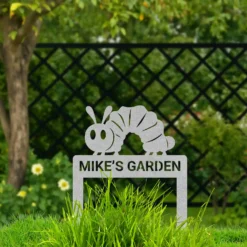 Silver colored metal caterpillar yard art with personalized name
