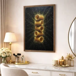 Framed canvas featuring gold glitter hair rollers displayed above a chic glam vanity dressing space.