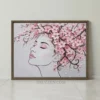 Minimalist female silhouette with pink cherry blossom hair on a grey framed canvas print.