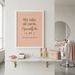 Cheeky beauty payment quote framed poster displayed above a makeup vanity in a chic pink glam room setting.
