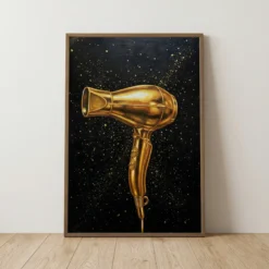 Metallic gold hair dryer with splatter on a black background on a framed canvas salon print.