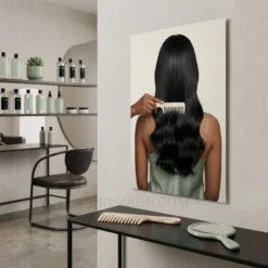 side angle view of silky black hair comb glossy metal print showing floating wall mount depth
