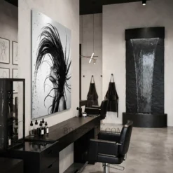 side angle view of black and white hair flip water splash metal print showing floating wall mount depth
